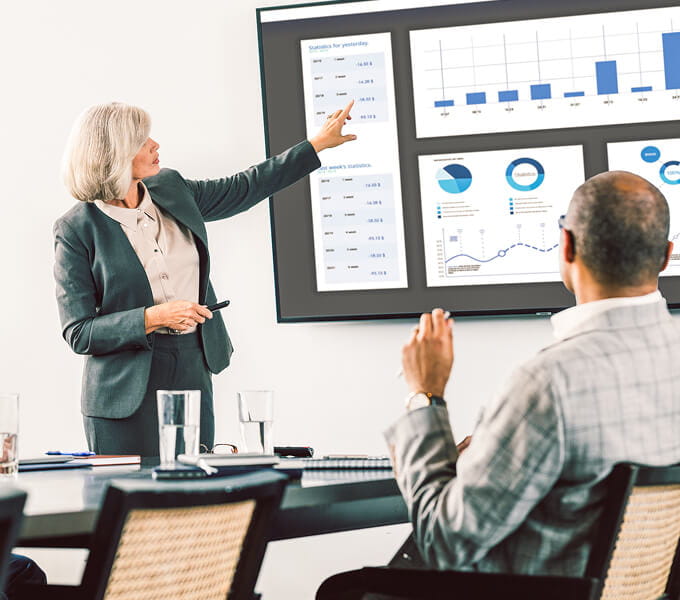 Experienced advisor going over data in board room.