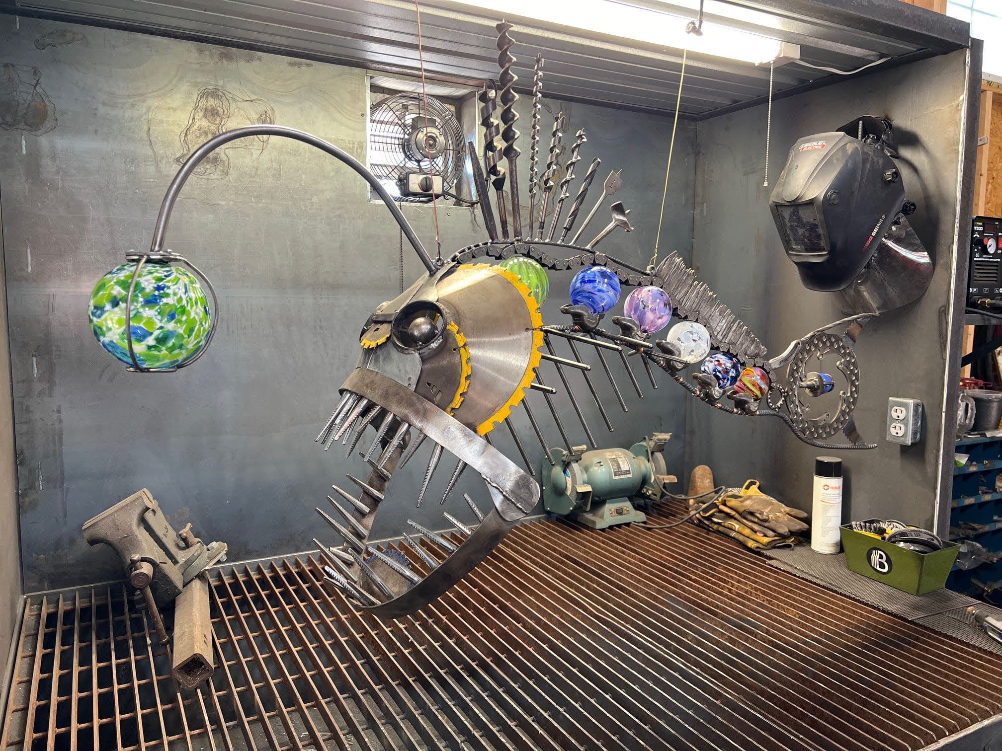 Tyler Matthew's sustainability piece titled "Fueled by Scrap Yards, Pabst Blue Ribbon, and Nightmares” is made from glass, metal and other repurposed materials.