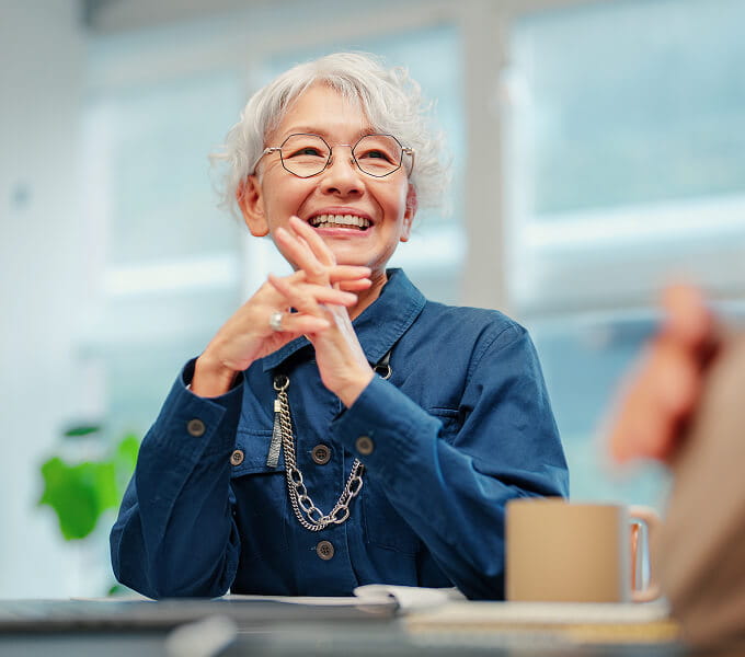 Retiree sitting with folded hands